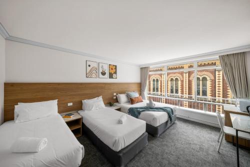 Postel nebo postele na pokoji v ubytování Kingsway Motel Geelong