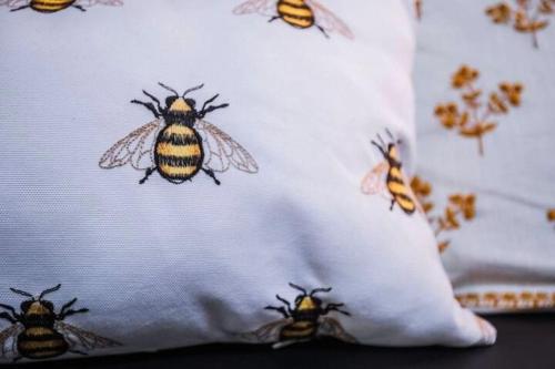 a group of bees on a pillow on a bed at BEES KNEES A-frame Cabin for 2 hot tub wifi in Gatlinburg