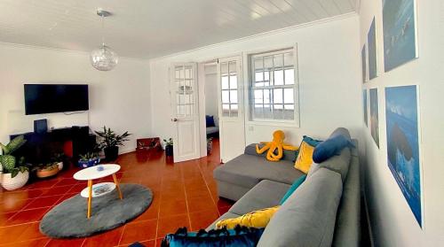 a living room with a couch and a table at SEASTAR nº36 in Horta