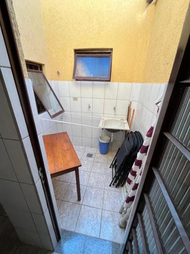 a small bathroom with a sink and a table at Casa amarela - Perto do Centro in Poços de Caldas