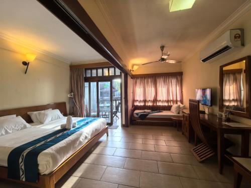 a hotel room with a bed and a desk and a table at Langkawi Lagoon Floating Resort 02 in Langkawi Intl