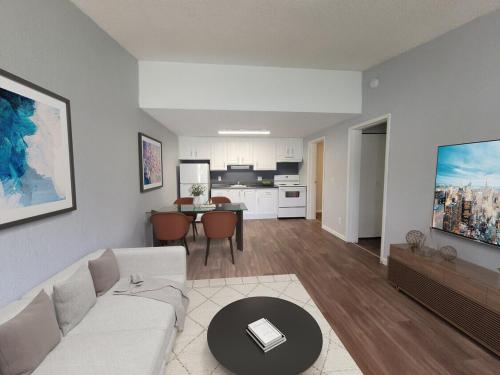 a living room with a white couch and a table at RNG apartment in Abbeyville