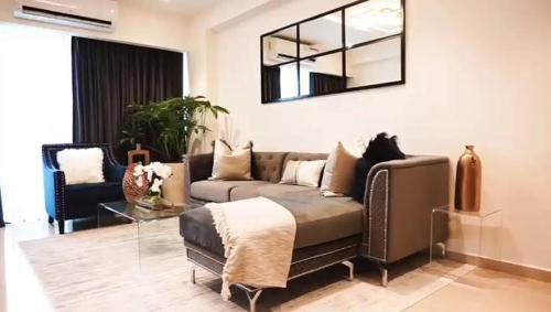 a living room with a couch and a glass table at RNG apartment in Abbeyville
