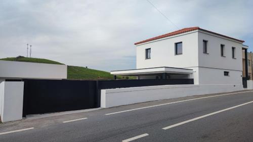 a white house on the side of a road at Casa da Corredoura in Santa Marta de Penaguião