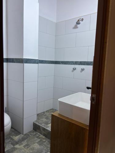 a white bathroom with a tub and a toilet at Lavanda lodge Ollantaytambo in Ollantaytambo