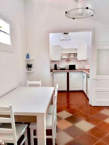 a kitchen with a white table and white chairs at SEASTAR nº36 in Horta