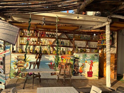 a store with a table and chairs in front of it at Hotel Los Chamos Barú in Cartagena de Indias