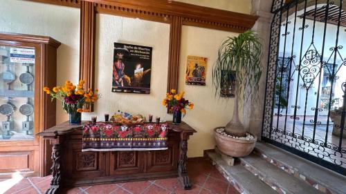 a room with a table with flowers on it at Casona Bartolome in Morelia