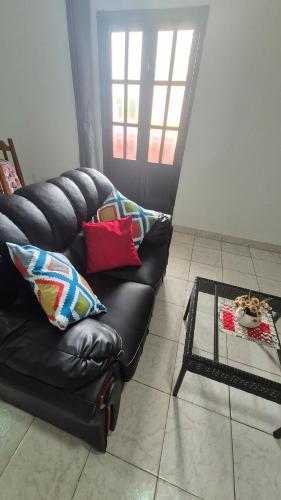 een zwarte leren bank in een woonkamer bij Apartmento en Encarnación in Encarnación