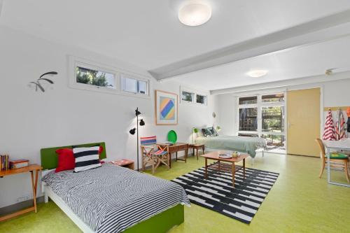 ein Schlafzimmer mit zwei Betten und ein Wohnzimmer in der Unterkunft The Lonsdale House in Point Lonsdale