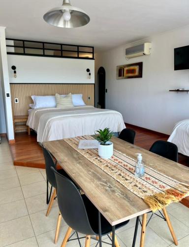 a bedroom with a bed and a wooden table at Solar de Roca in Embalse