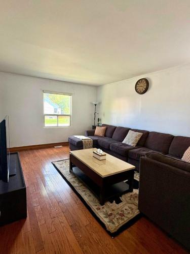 a living room with a couch and a coffee table at Cozy 3BR House Near Airport & Transit! in Mississauga