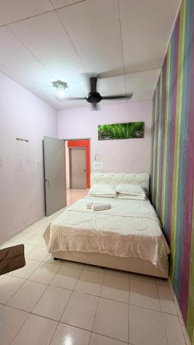 a bedroom with a large bed in a room at Zuma Homestay in Sungai Buluh