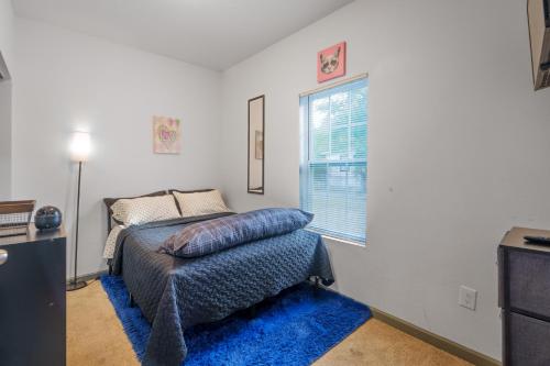 a bedroom with a bed and a window at Stylish & Quiet 3BD Sleeps 8 Near Stadium & Downtown in Jacksonville