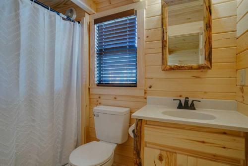 a bathroom with a toilet and a sink and a mirror at Angel Fire RV Resort in Angel Fire