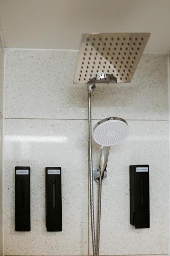 a bathroom with a shower with three controls on a counter at The Bay Crib in Ottawa