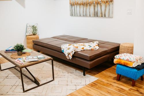 a living room with a brown couch and a table at The Bay Crib in Ottawa