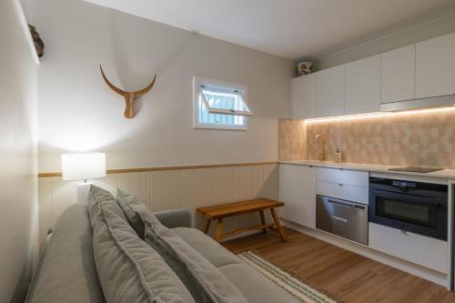 a living room with a couch and a table at Hibiscus Cottage in Ballina
