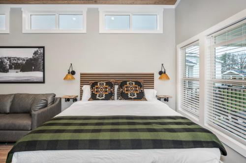 a bedroom with a bed and a couch and windows at Carolina Camp Cedar in Pickens