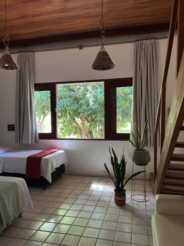 a bedroom with a bed and two windows at Casa do Luar I Alagoas I Nordeste-Coruripe in Coruripe