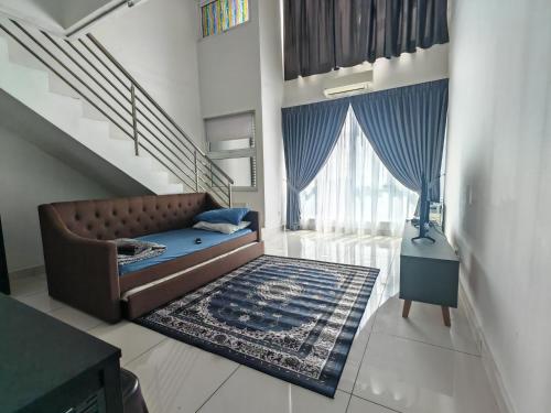 a living room with a couch and a staircase at De Centrum Residences in Kajang