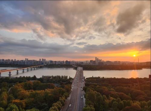a bridge over a highway with a city in the background at Healing House in Seoul