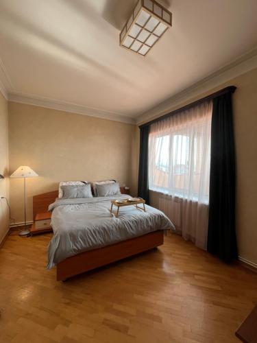 een slaapkamer met een groot bed en een raam bij Noah's sunlight villa hostel in Jerevan