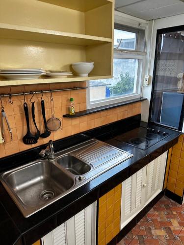 a kitchen with a stainless steel sink and a window at Pattaya Beach Condominiumby Ahmed in Pattaya