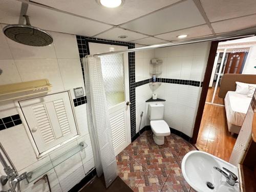 a bathroom with a toilet and a sink at Pattaya Beach Condominiumby Ahmed in Pattaya