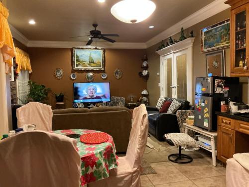 a living room with a couch and a tv at Barry and Elaine in Abbotsford