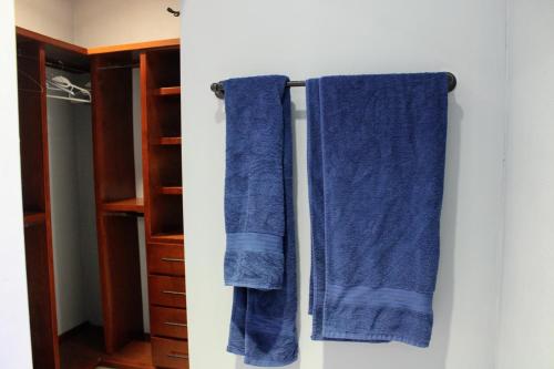 two blue towels hanging on a wall in a closet at Casa de Ciencia, Cultura y Buena Onda in La Paz