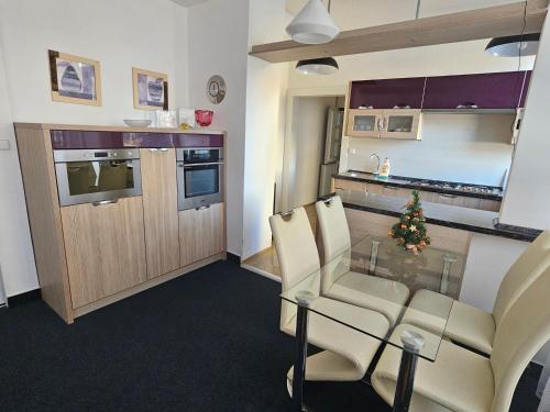 a kitchen with a christmas tree on a glass table at Apartmán Vintage A2 v Chomutově in Chomutov
