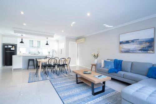 a living room with a couch and a table at 30 Modern & Quiet Retreat -Walk to Dining & Shops in Perth