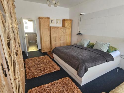 a bedroom with a bed in a room with rugs at Apartmán Vintage A2 v Chomutově in Chomutov