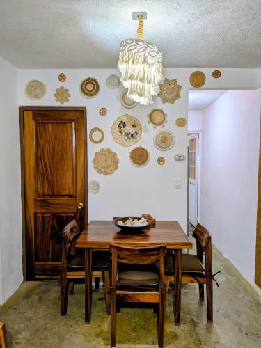 a dining room with a table and plates on the wall at Ixtapa al mejor precio, "Casa las Conchas" in Zihuatanejo