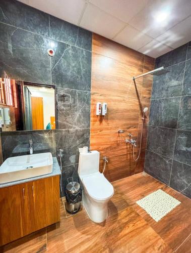 a bathroom with a toilet and a sink and a shower at Rivero Resort in Dirang Dzong