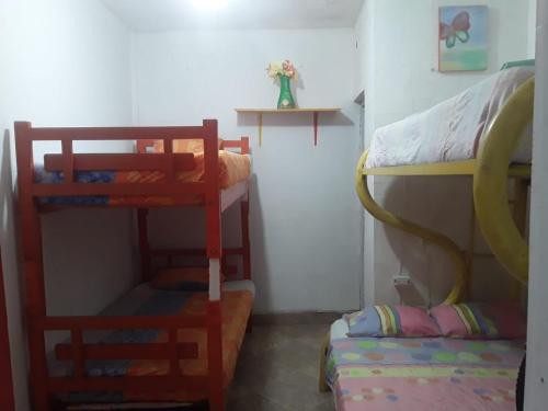 a room with two bunk beds and a bed at Caribe Tolú in Tolú