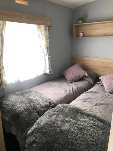 a bedroom with two beds next to a window at Withamside Country Park in Boston
