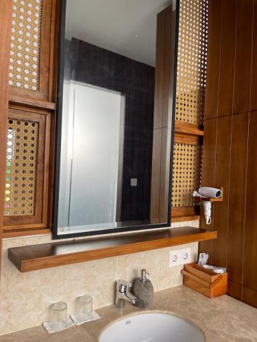 a bathroom sink with a large mirror above it at SVARGA RENJANA ViLLA in Lombok