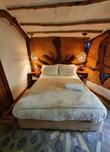 a bedroom with a large bed in a room at Condado de Casa Grande in San Gil