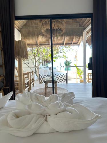 une assiette blanche posée sur un lit dans l'établissement Sama Beach Resort by Munchies Resort, à Baan Tai