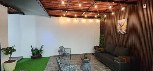 a living room with a couch and a table and chairs at Casa Fénix in Comala