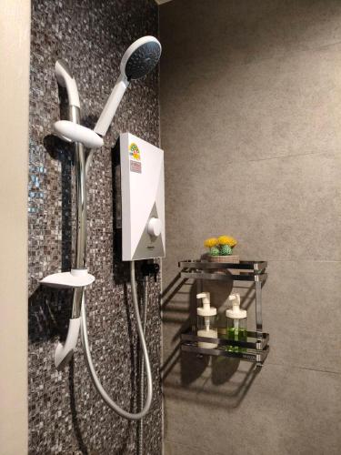 a shower in a bathroom with a shower head at Le Wadee Residence in Bang Tao Beach