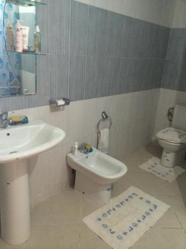 a bathroom with a sink and a toilet at Cabobeach Appartement in Cabo Negro