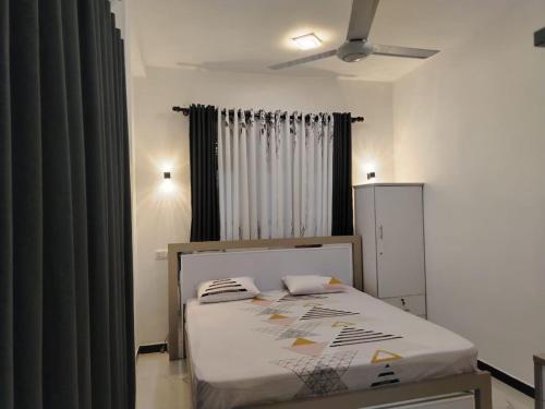 a bedroom with a bed in a room at Stay Roside Villa Hikkaduwa in Hikkaduwa