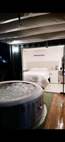 a room with a large tub with two beds at Atacama container in Brasília