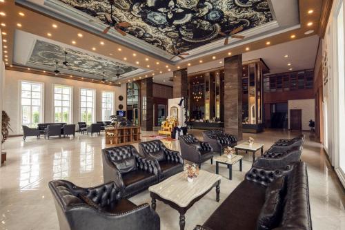 a lobby with couches and tables in a building at Le Erawan Phang Nga Hotel in Phangnga