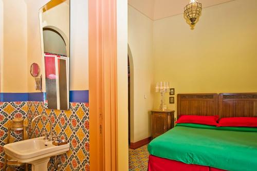 a bedroom with a bed and a sink and a mirror at Casa Astarita in Sorrento