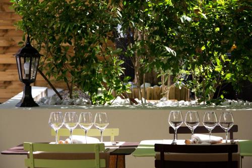 a table with wine glasses on top of it at Hotel De Paris Jaligny in Jaligny