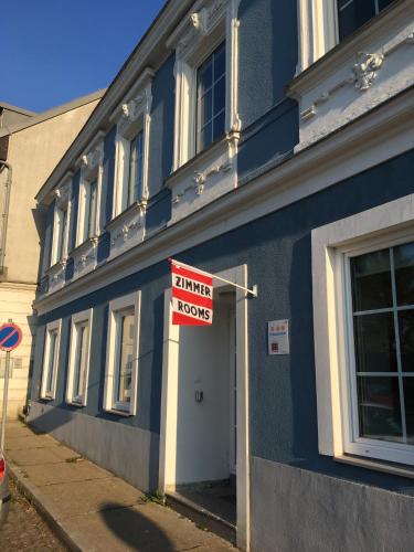 a blue building with a sign on the side of it at Alte Post Greifenstein in Greifenstein